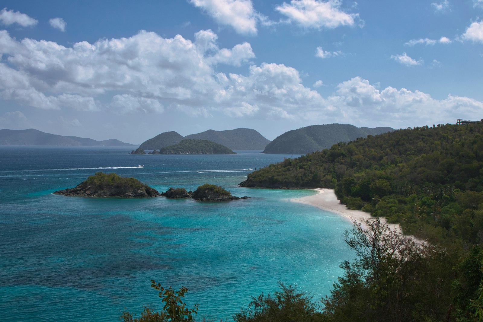 Turquoise Caribbean bay surrounded by green hills on St. John, US Virgin Islands — the kind of water that makes you forget you packed a fly rod